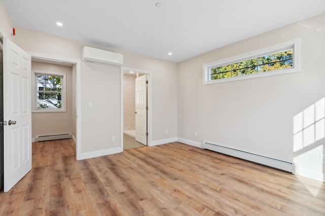 unfurnished bedroom featuring a baseboard heating unit, multiple windows, and a wall mounted air conditioner