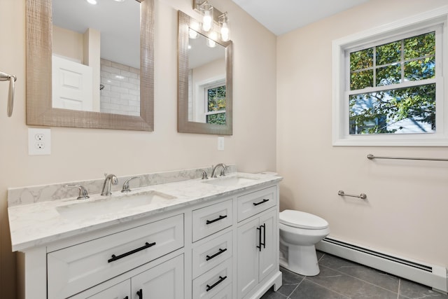 bathroom with toilet, tile patterned floors, a baseboard heating unit, and a sink