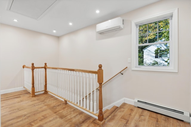staircase featuring wood finished floors, baseboards, recessed lighting, a wall unit AC, and a baseboard radiator