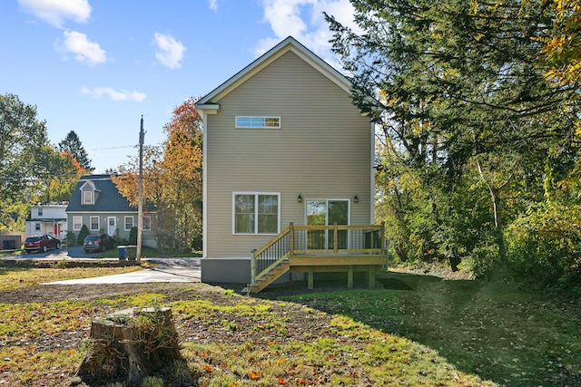 back of property featuring a wooden deck