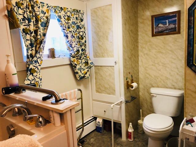 bathroom featuring toilet and baseboard heating