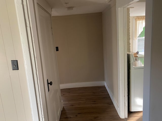 hallway featuring washer / dryer and dark hardwood / wood-style flooring