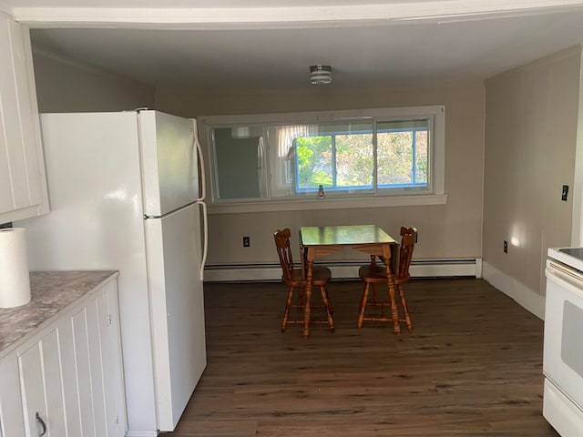 dining space with dark hardwood / wood-style floors