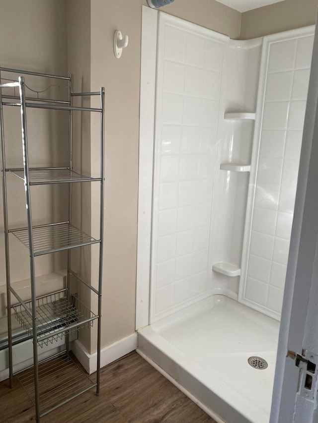 bathroom featuring a shower and wood-type flooring