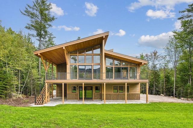 rear view of house with a lawn and a patio area