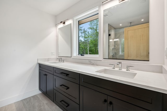 bathroom with vanity and a shower with door