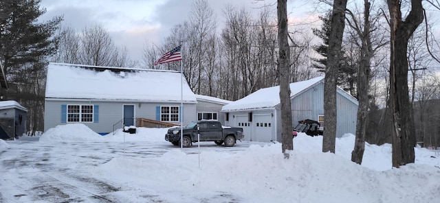 view of front of property featuring a garage and an outbuilding