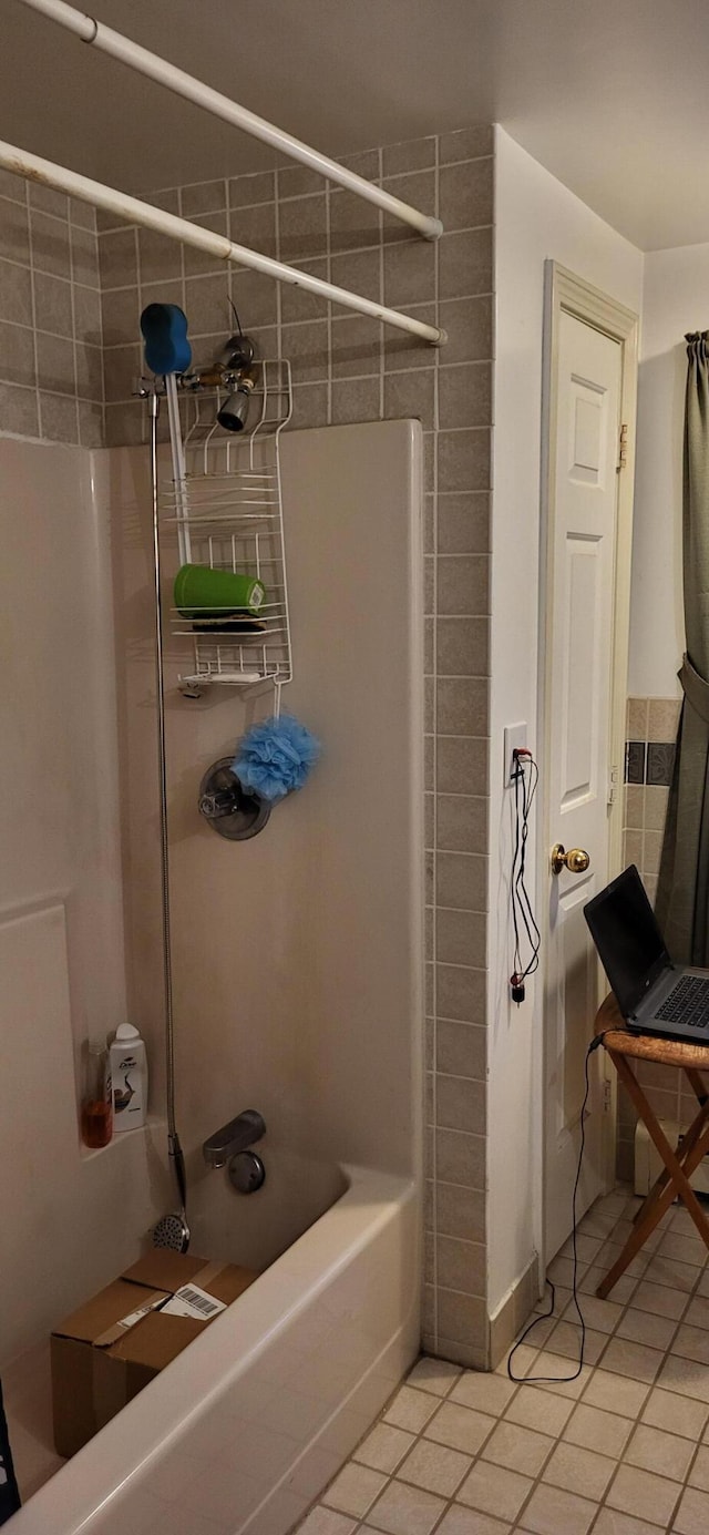 bathroom with tile patterned floors and tiled shower / bath