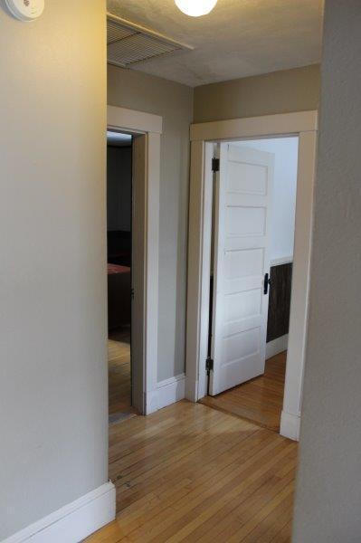 corridor with light hardwood / wood-style floors