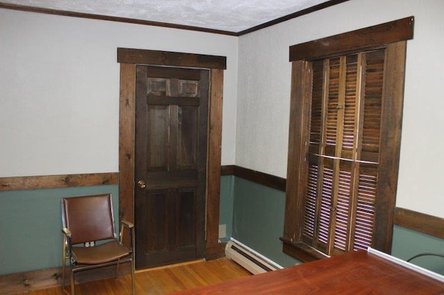 entrance foyer featuring crown molding, dark hardwood / wood-style floors, and baseboard heating