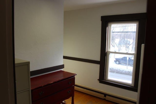 interior space with baseboard heating and light hardwood / wood-style floors