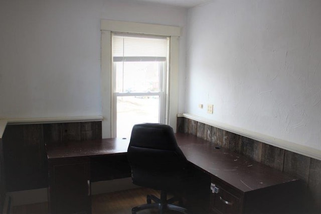 home office with dark hardwood / wood-style flooring