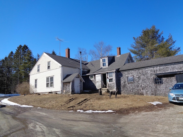 view of front facade with an outbuilding and a shed