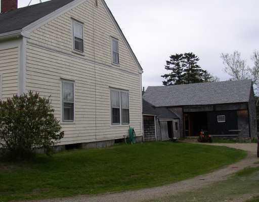 view of side of property with a lawn