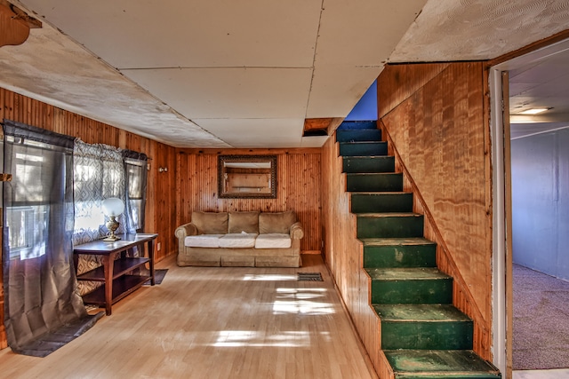 interior space with light hardwood / wood-style flooring and wooden walls