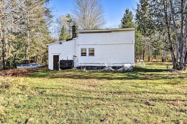 64 Ferrin Rd, Litchfield, ME 04350 - rear view of property with a lawn