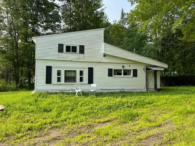 rear view of property with a yard