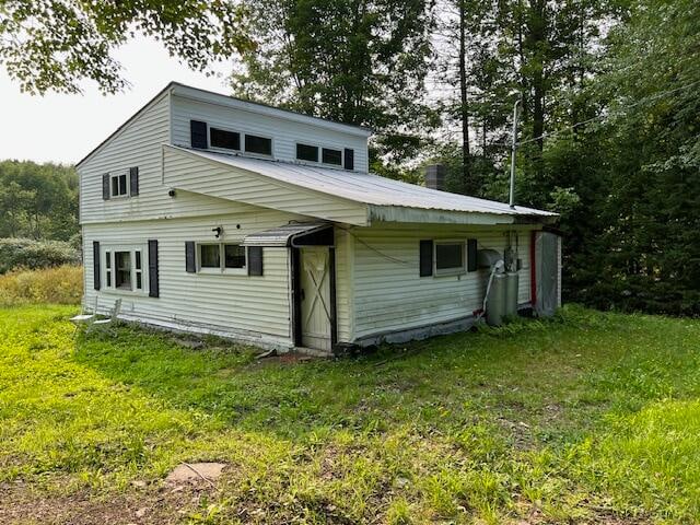 back of house with a yard