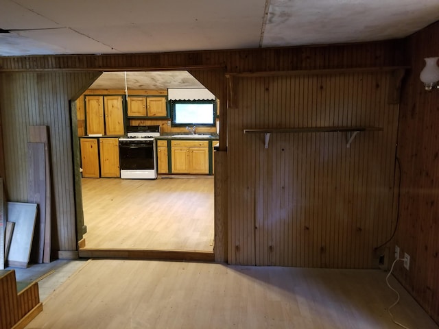 64 Ferrin Rd, Litchfield, ME 04350 - kitchen with light wood-style flooring, a sink, white range with gas stovetop, and wooden walls