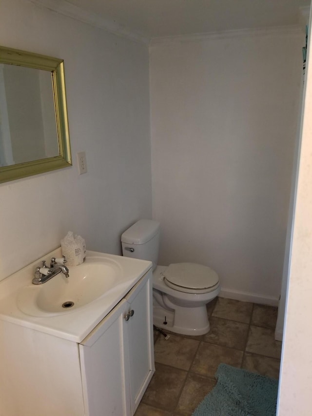 bathroom with ornamental molding, vanity, toilet, and tile patterned flooring