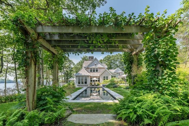 29 Summerhaven Ln, Boothbay, ME 04544 - rear view of house featuring a chimney, a pergola, and a water view