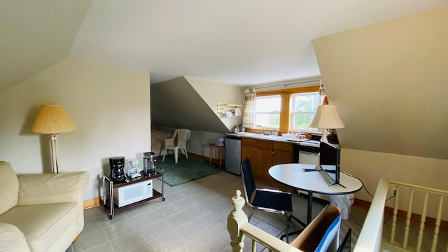 interior space with light tile flooring and vaulted ceiling