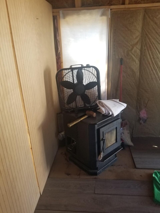 interior details with dark wood-type flooring and a wood stove