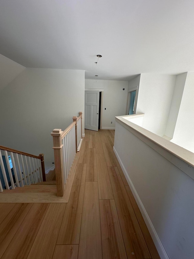 corridor with light hardwood / wood-style floors