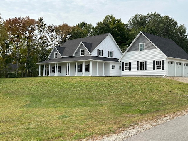 country-style home with covered porch, a garage, and a front lawn