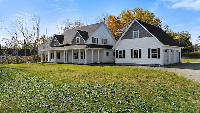 back of property featuring a yard, a garage, and covered porch