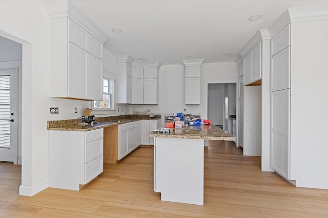 LOT1 Honey Hill Ests W, Hampden, ME 04444 - kitchen with light wood-style floors, a kitchen island, stone countertops, and white cabinetry