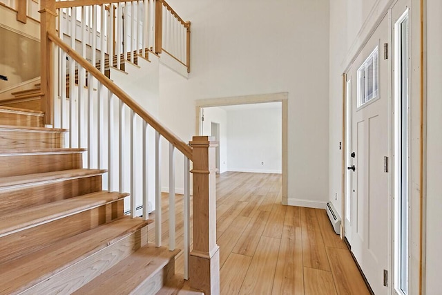 LOT1 Honey Hill Ests W, Hampden, ME 04444 - foyer with wood-type flooring, stairway, a baseboard heating unit, and a high ceiling