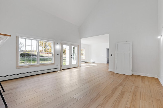 unfurnished living room with french doors, light hardwood / wood-style flooring, a baseboard heating unit, and high vaulted ceiling