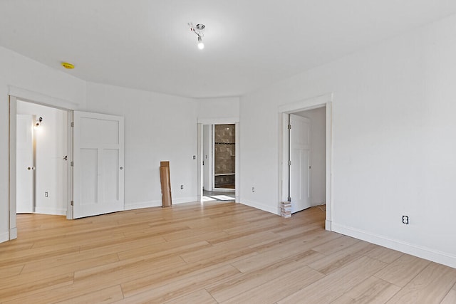 spare room featuring light wood-type flooring