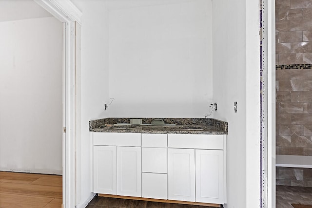 bathroom with hardwood / wood-style flooring