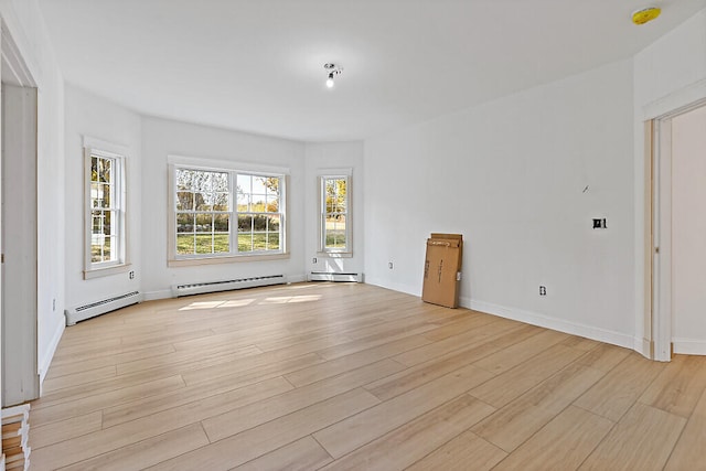 empty room with light hardwood / wood-style flooring and a baseboard radiator