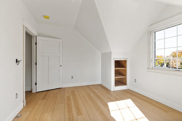 bonus room featuring vaulted ceiling and light hardwood / wood-style flooring