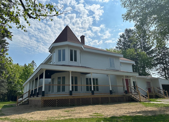 rear view of house featuring covered porch