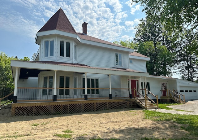 exterior space with a porch and a garage