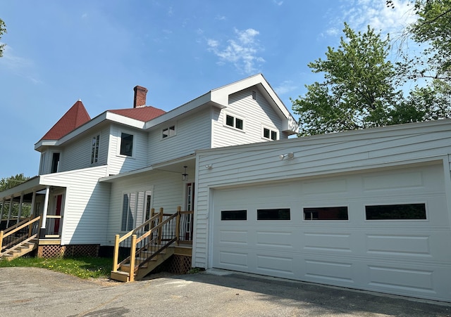 rear view of house with a garage