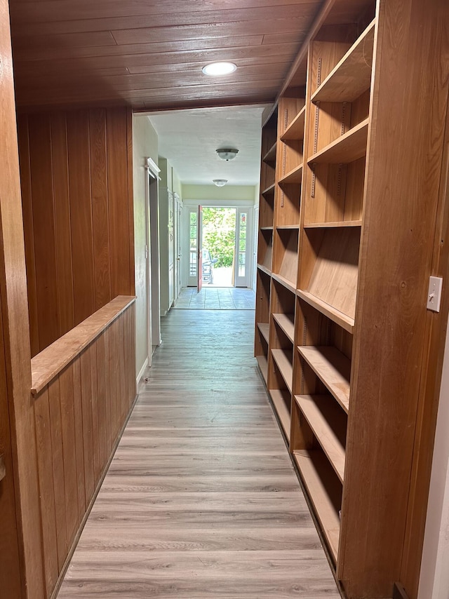 interior space featuring light hardwood / wood-style floors and wooden walls