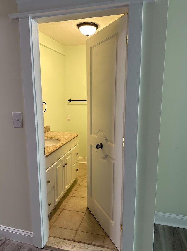 bathroom with tile floors and vanity