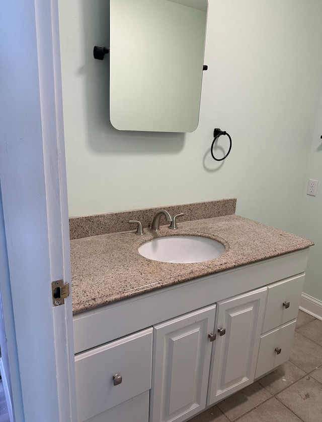 bathroom with tile floors and vanity