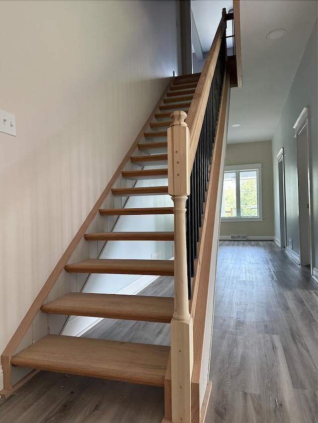 stairway featuring dark hardwood / wood-style flooring