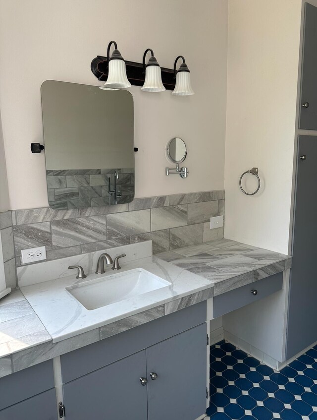 bathroom with backsplash, tile floors, and vanity