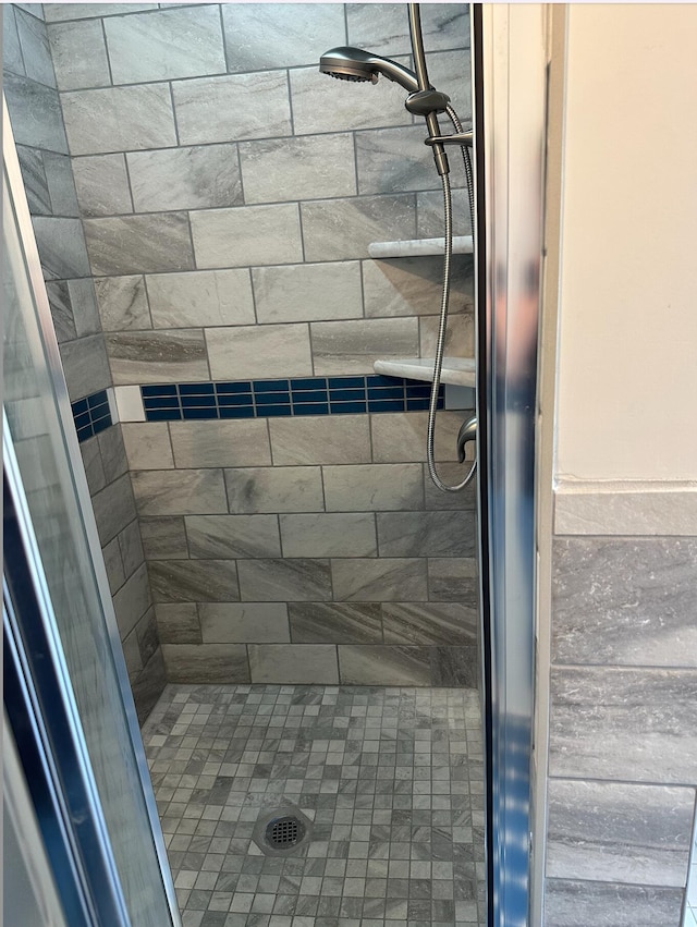 bathroom with tiled shower