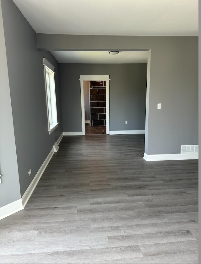 unfurnished room with hardwood / wood-style floors