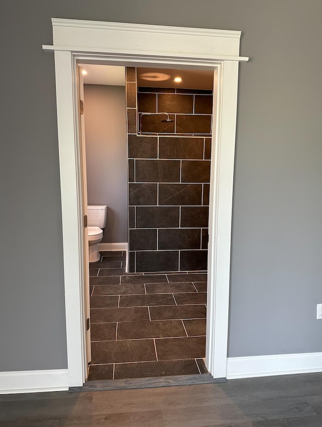 interior space with toilet and hardwood / wood-style flooring