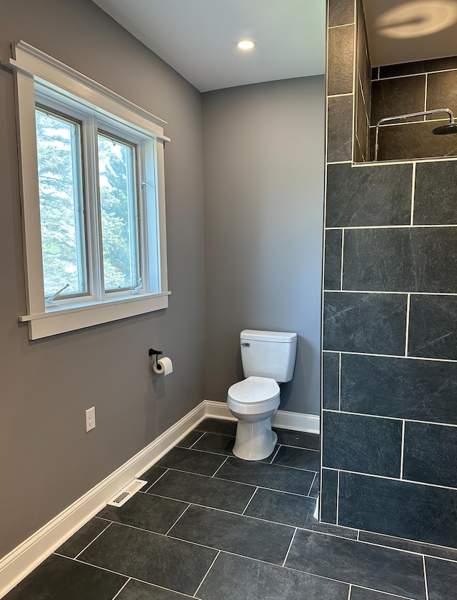 bathroom with tile floors and toilet