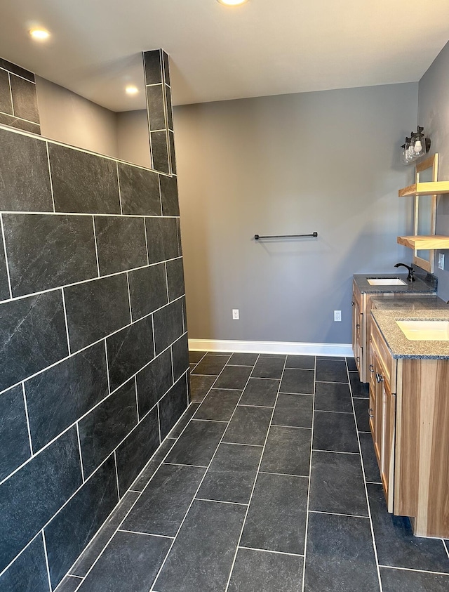 bathroom with tile flooring, dual sinks, and oversized vanity